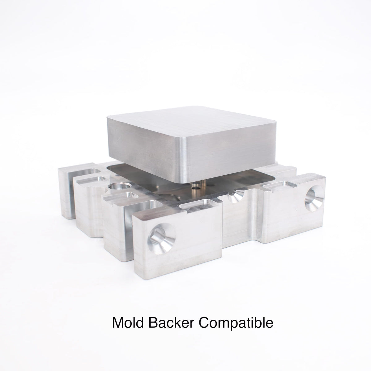Aluminum mold blank seated on a mold backer, showing mold backer compatible mounting for injection molding.