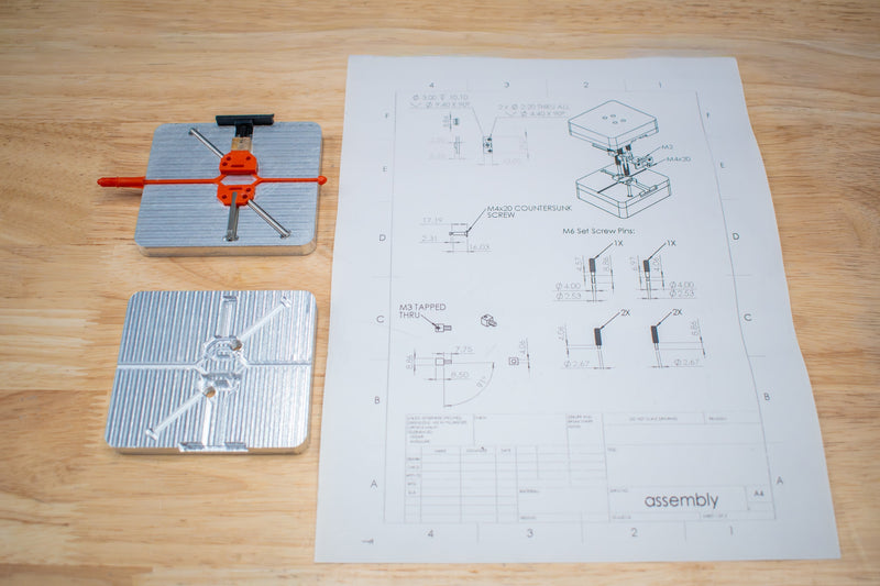 Plastic injected part using INJEKTO 3 with mold designs on paper.