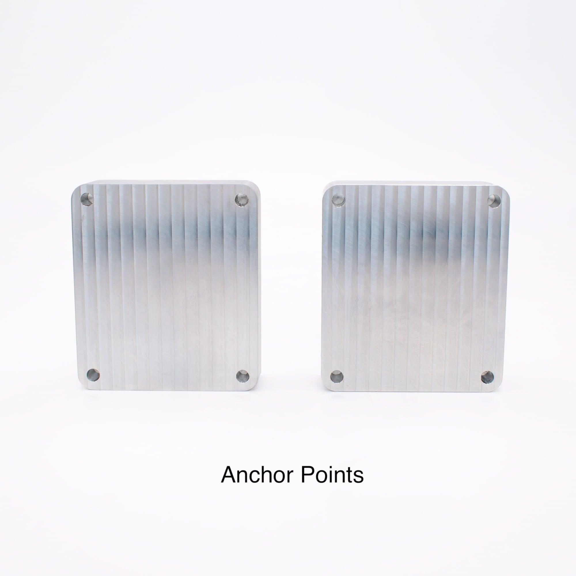 Back of two aluminum mold blanks showing four countersunk anchor points for rigid mold backer clamping.
