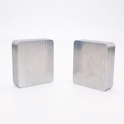 Two unmachined 6061-T6 aluminum mold blanks ready to be milled into custom injection molds.