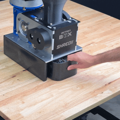 SHREDII 8 collection bin sliding out smoothly beneath the shredder, showing easy cleanup of shredded plastic materials.